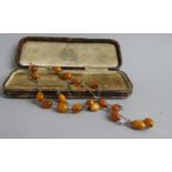 An Early Gold Metal Necklace set with Eighteen Ovoid Buterscotch Amber Beads in Box for Charles