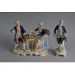 A Continental Figural Group, Seated Couple Playing Chess together with a Standing Gent.