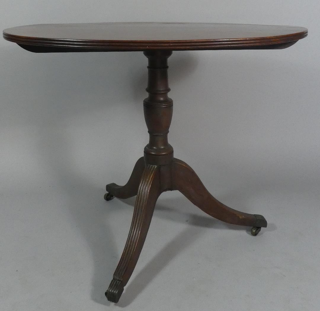 A 19th Century Mahogany Oval Topped Former Snap Top Tripod Table, 91cm Wide