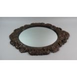 A 1950s Carved Oak Effect Oval Mirror by Gomme, 68cms High