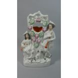 A 19th Century Staffordshire Flat Back Pocket Watch Stand (AF) with Seated Lady and Standing Gent,