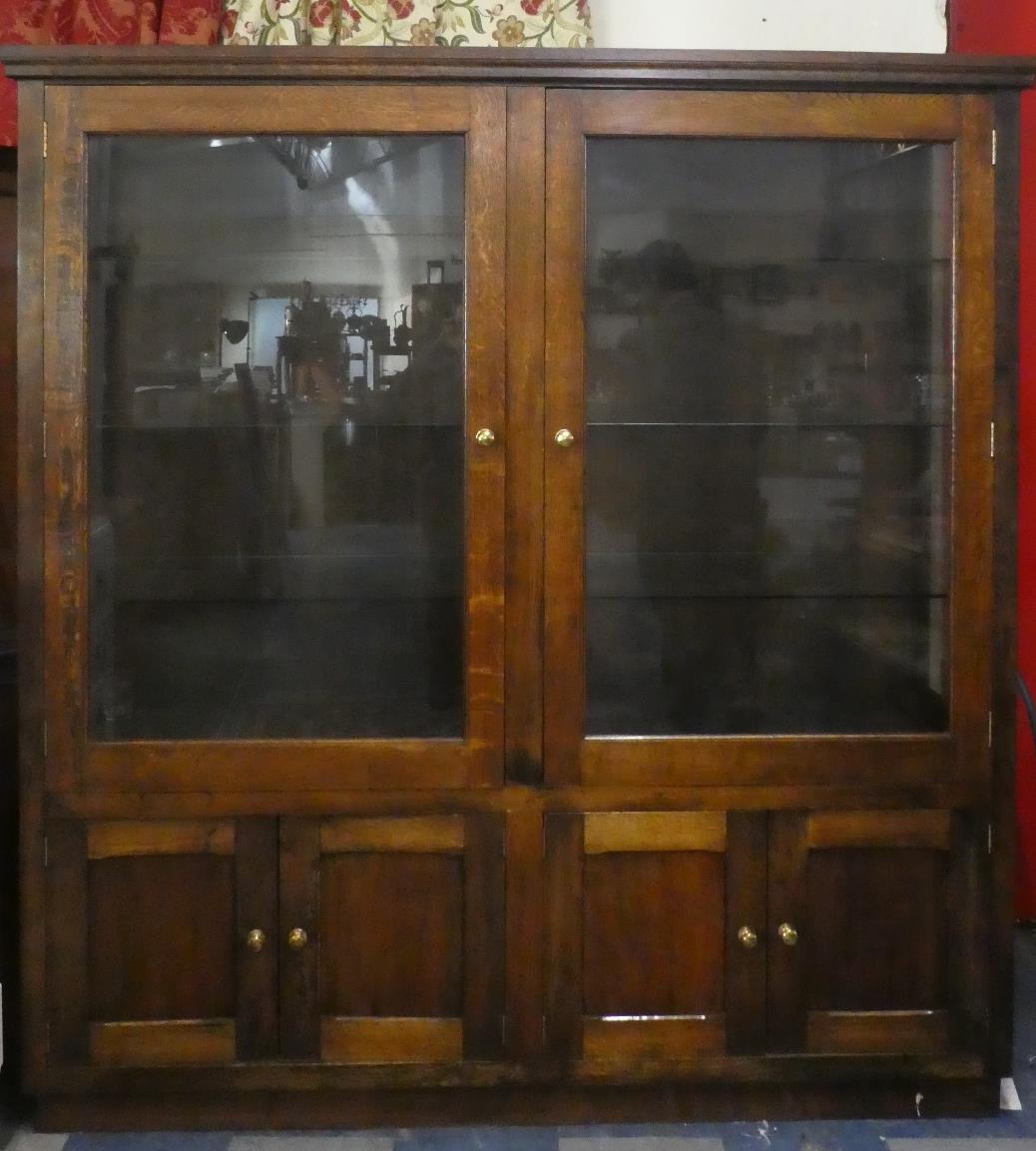 A Large Oak Glazed Shop Display Cabinet with Three Glass Shelves and Cupboard Base, 192cm Wide