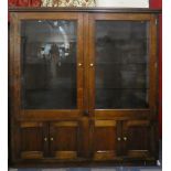 A Large Oak Glazed Shop Display Cabinet with Three Glass Shelves and Cupboard Base, 192cm Wide