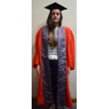 A Graduation Gown and Mortar Together with Other Accessories and Fabrics
