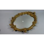 An Ornate Gilt Framed Oval Wall Mirror, 64cm High