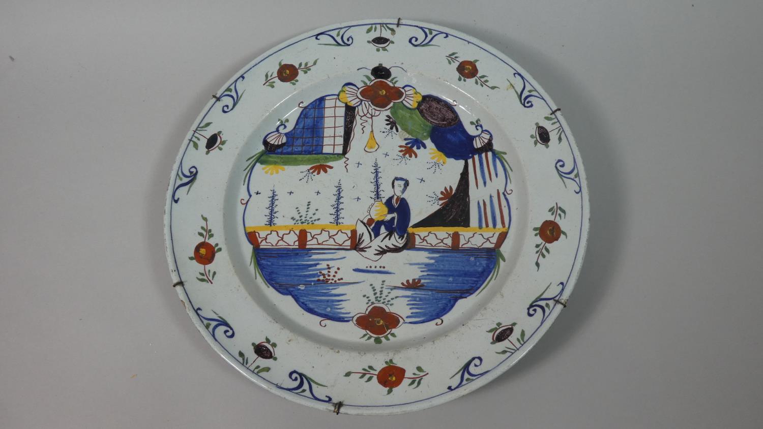 A Delft Polychrome Charger, C.1750 Painted in Blue, Iron Red, Yellow, Purple and Green. Decorated