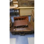 A Vintage Leather Suitcase, Leather Briefcase, and Small Case