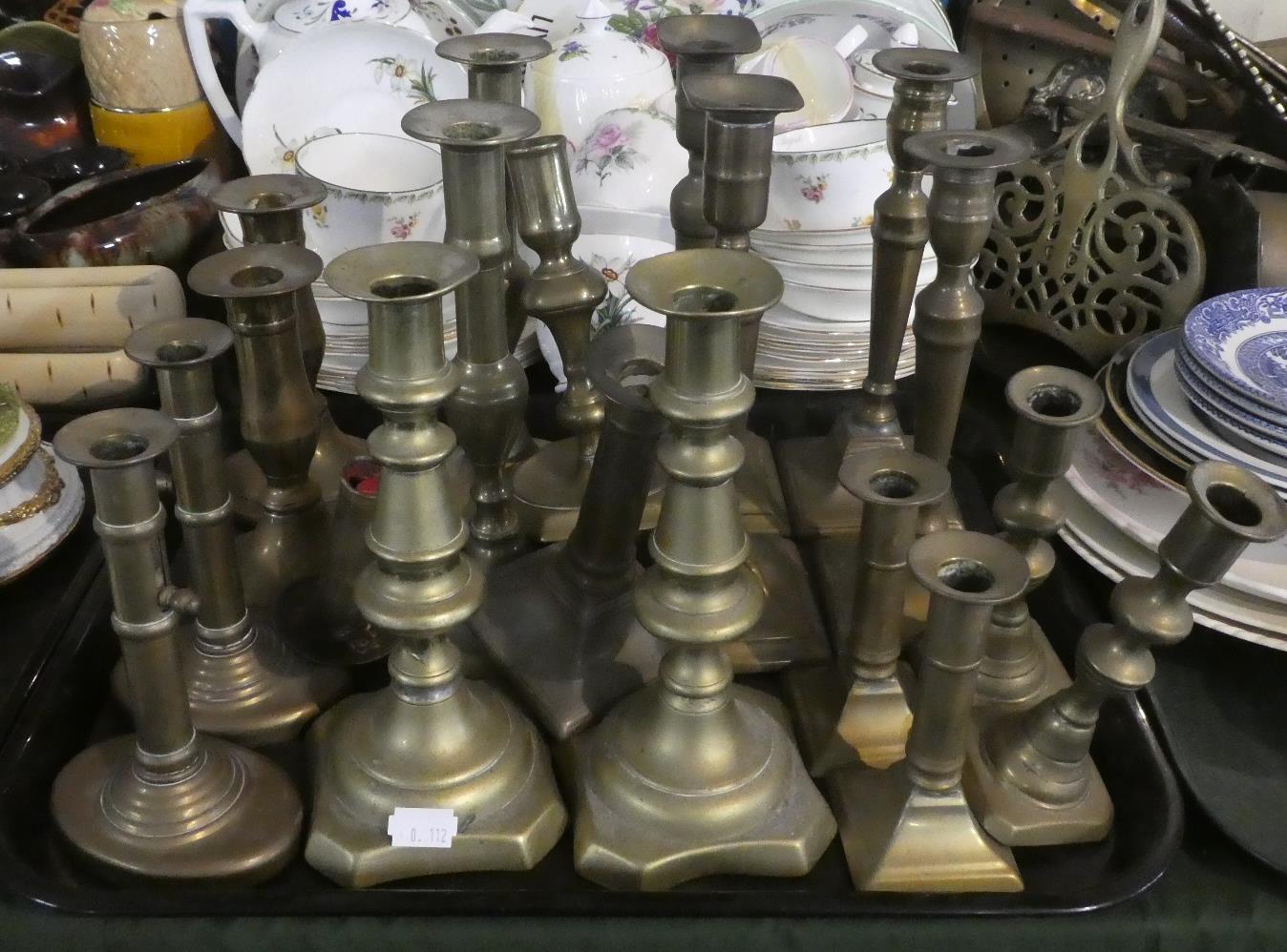 A Tray Containing Eight Pairs of Brass Candle Sticks