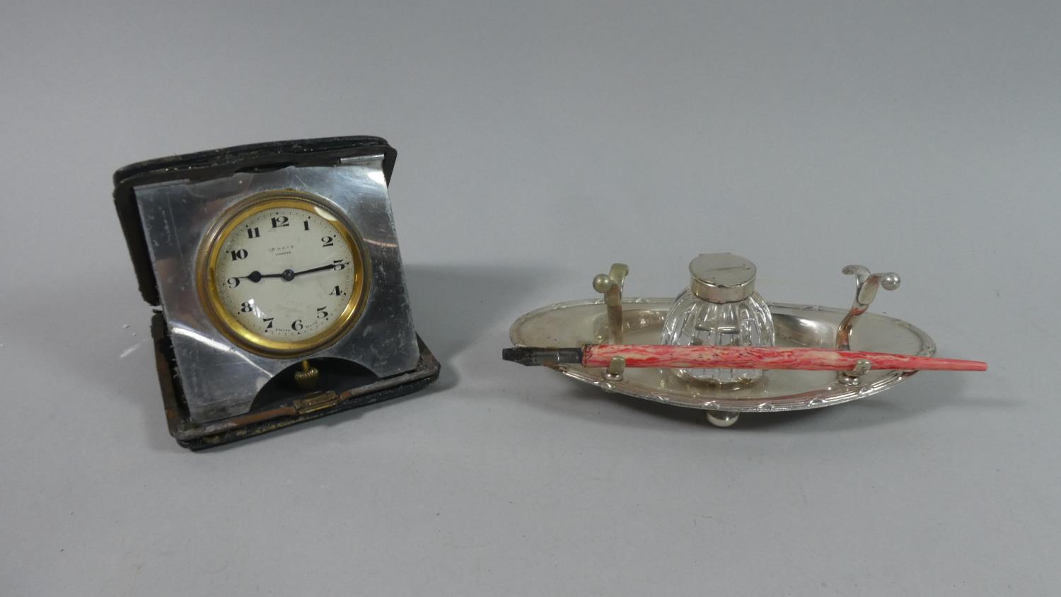 An Edwardian Travel Clock and a Silver Plated and Glass Oval Desktop Inkstand