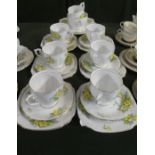 A Bell China Primrose Pattern Tea Set Comprising Six Trios, Cake Plate, Cream and Sugar