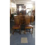 An Edwardian Oak Sideboard and Four Dining Chairs