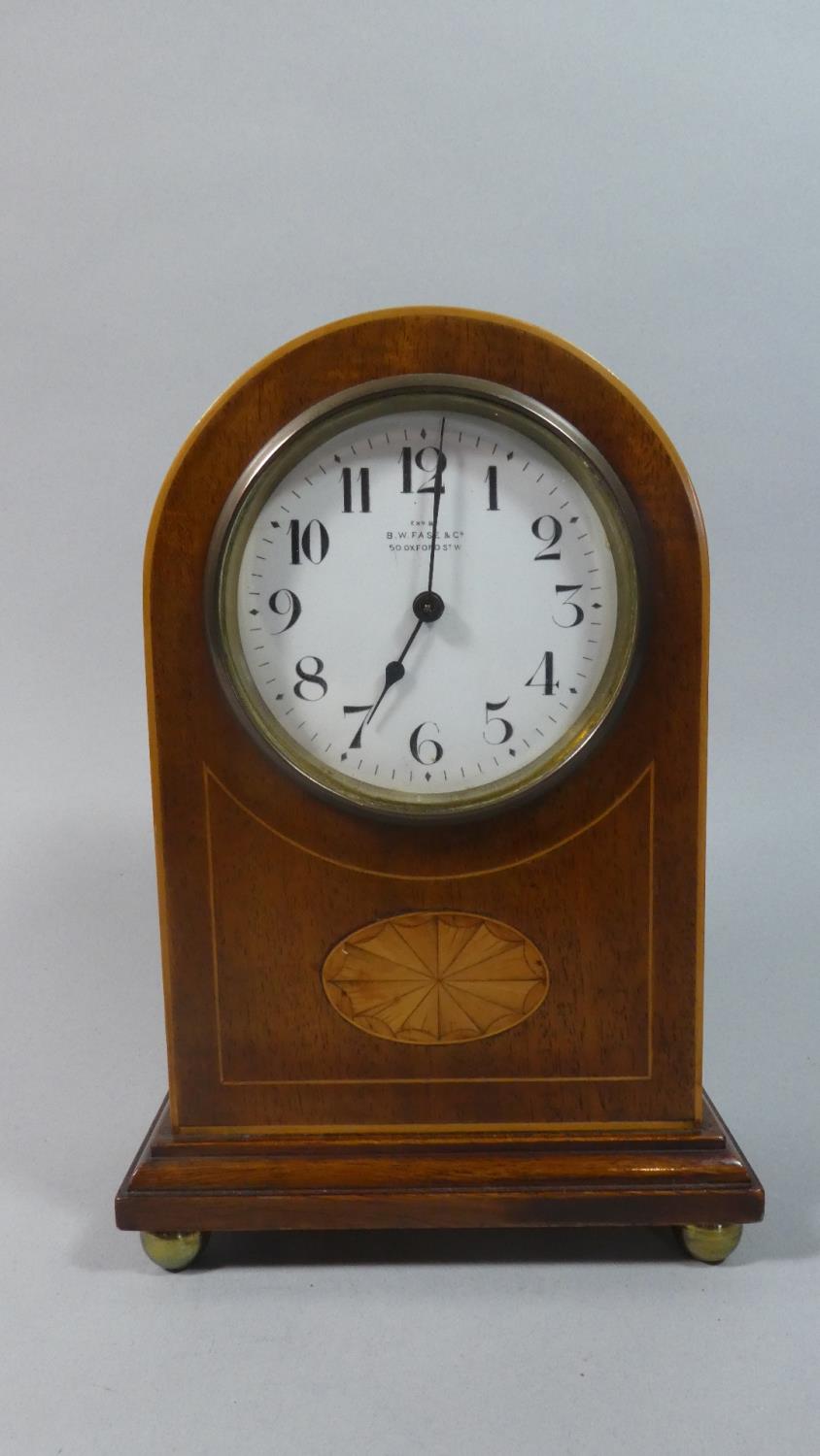 An Edwardian Inlaid Mahogany Arched Topped Mantel Clock with White Enamelled Dial For B W Fase & Co.