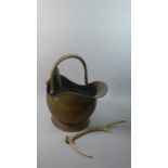 A Brass Helmet Shaped Coal Scuttle, Shovel and Antler