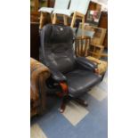 A Swivel Arm Chair with Blue Leather Upholstery