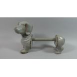 A Cast Iron Effect Kitchen Roll Holder in the Form of A Sausage Dog, 34cms Long