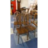 A Set of Four Hooped Back Dining Chairs with Wheel Splats