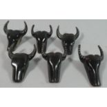 A Collection of Six American Style Horn Toggles in the Form of Buffalo Heads