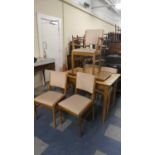 A Vintage Russell of Broadway Dining Suite comprising Extending Dining Table and Four Chairs