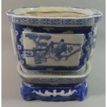 An Oriental Blue and White Planter on Stand decorated with Figures, Bats Etc, 25.cms Wide