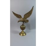 A Large Brass Study of Eagle Alighting on Globe, 49cms High