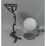 A Modern Chrome Bedside Light with Opaque Glass Shade together with a Wrought Iron Candle Pricket of