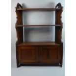 A Late Victorian Wall Hanging Mahogany Shelf Unit with Two Supports and Cupboard Base, 61cms Wide