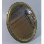 A Reproduction Brass Framed Oval Mirror in the WMF Style, 33cms High