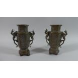 A Pair of Oriental Bronze Hexagonal Temple Vases with Acid Etched Decoration and Dragon Handles,