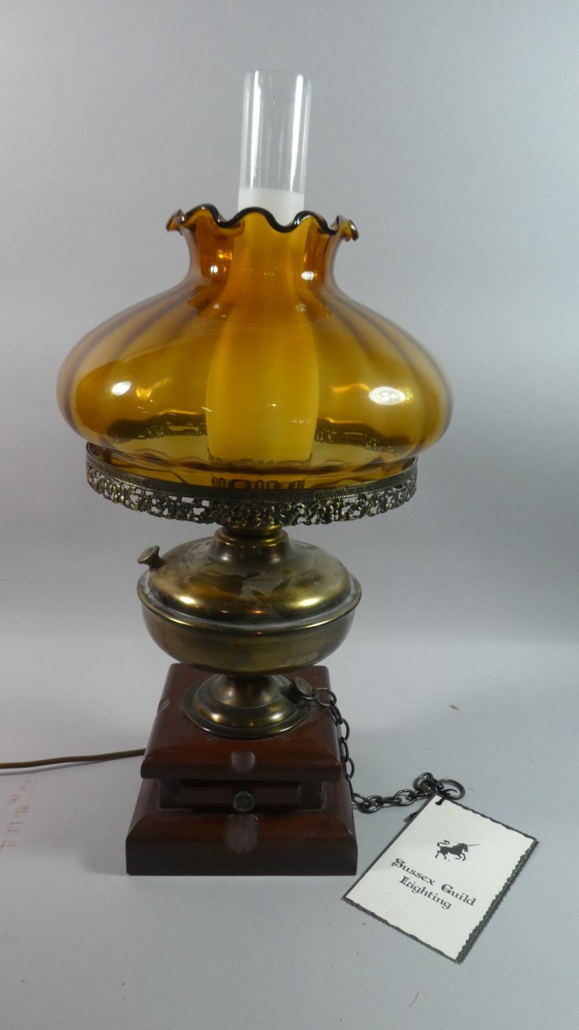 A Vintage Style Brass and Wooden Table Lamp by Sussex Guild Lighting with Amber Glass Shade