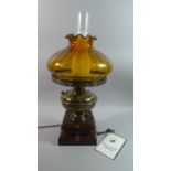 A Vintage Style Brass and Wooden Table Lamp by Sussex Guild Lighting with Amber Glass Shade