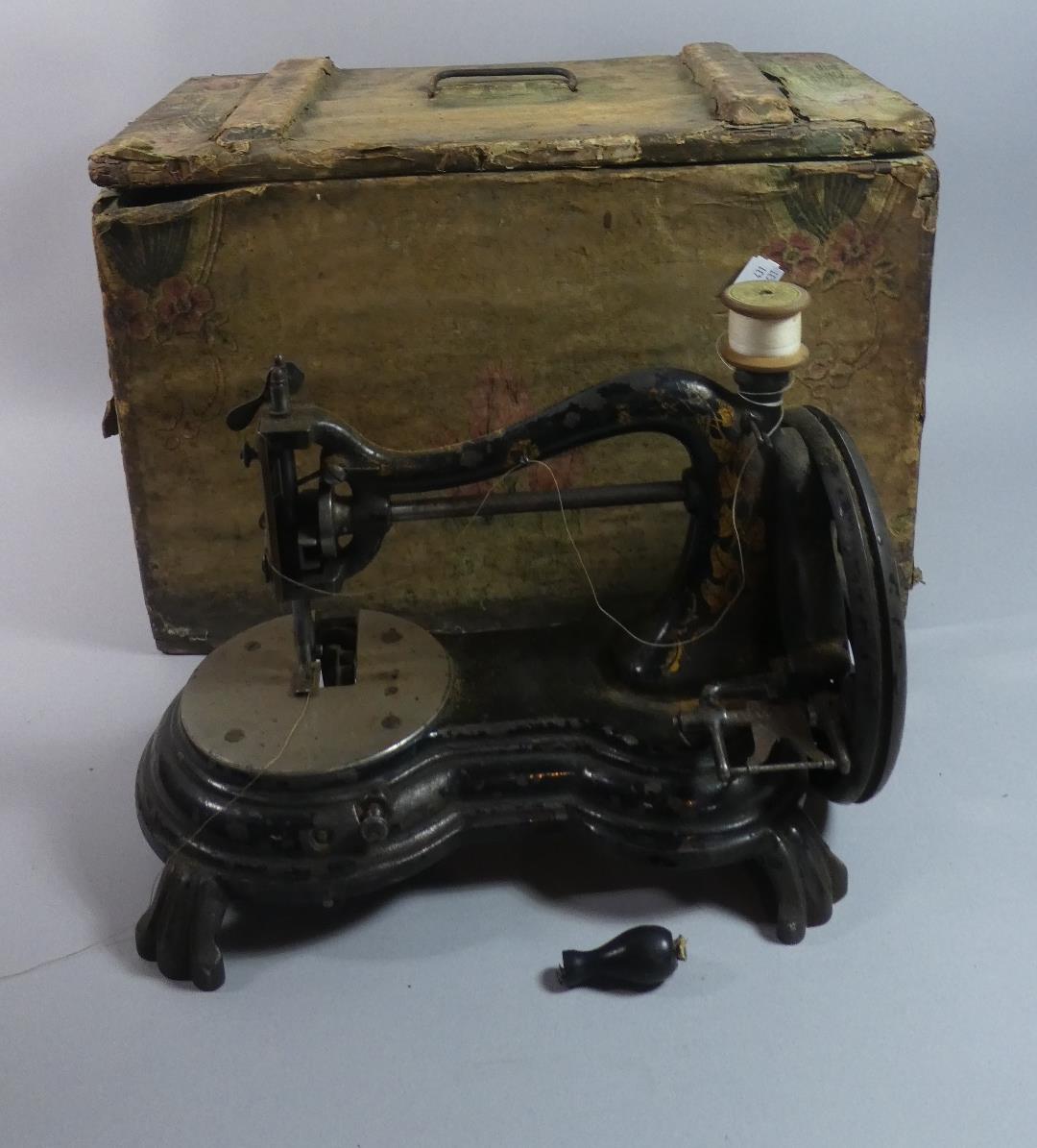 An Early Sewing Machine in Wooden Box
