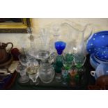 A Tray of Coloured and Plain Glassware to Include Large Water Jug, Two Decanters, Drinking Glasses