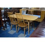 An Ercol Dining Table and Four Spindle Back Chairs