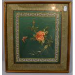A Framed Oriental Silk Panel with Embroidered Border and Hand Painted Centre Depicting Rose and