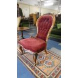 A Victorian Walnut Framed Upholstered Balloon Back Nursing Chair with Serpentine Front and