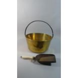 A Large Brass Jam Kettle with Iron Loop Handle Together with a Ceramic Handled Shovel, 35cm Diameter