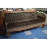 A Large Oak Framed Late 19th/Early 20th Century Buttoned Upholstered Settle with Carved Gothic