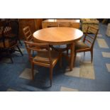 A 1970's Circular Oak Dining Table and Four Ladder Back Chairs