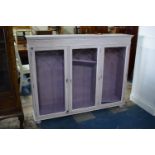 A Mauve Painted Glazed Triple Bookcase, 145cm Wide