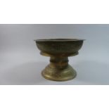 An Indian Brass Temple Bowl on Stand with Decoration in Relief, 25cm Diameter