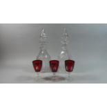 A Pair of Late 19th Century Mallet Decanters and Three Overlaid Wine Glasses