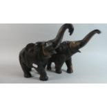 A Pair of Carved African Ebonised Studies of Elephants with Trunks in Saulute, 32cm Long