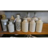A Collection of Nine Vintage Stoneware Bottles, Three With Painted Labels for Goodwin, Gothard and
