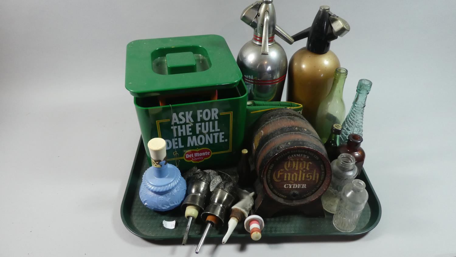 A Tray of Sundries to Include Two Vintage Soda Siphons, Two Knight Helmet Spirit Pourers, Collectors