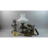 A Collection of Two Brass Blow Torches and Three Oil Lamps