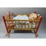 A 1950s Toy Rocking Cradle and Plastic Doll