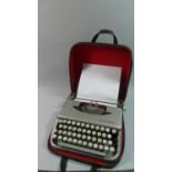 A Vintage Empire Corona Manual Portable Typewriter with Carrying Case Together with a Combination