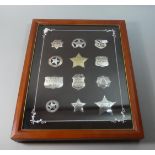 A Framed Set of Twelve Sterling Silver Replica American Police, Sheriff, Ranger and Marshal Badges