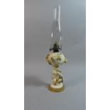 A Late 19th Century Figural Oil Lamp, The Support in the Form of Winged Cherub Holding Hops Complete