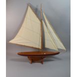 A Brass Mounted Wooden Model of a Sailing Yacht, 74cm Long